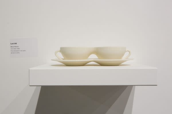 Photograph of ceramic teacups joined together on a plinth 