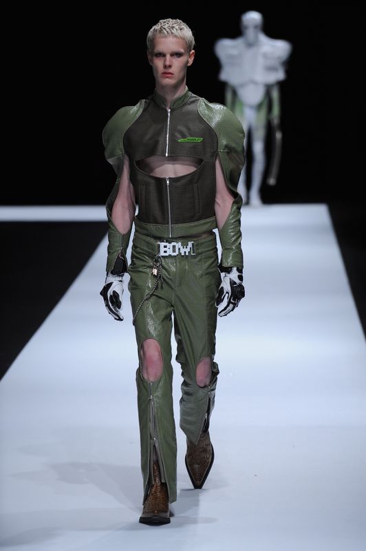 Blonde male model with green leather outfit