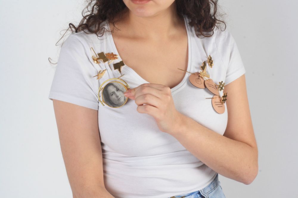 Model wearing handmade badges on a white tshirt