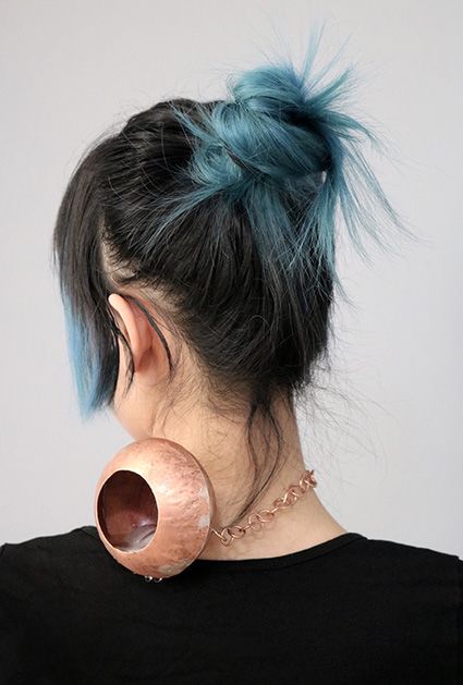 Copper vessel sitting on the back of a neck
