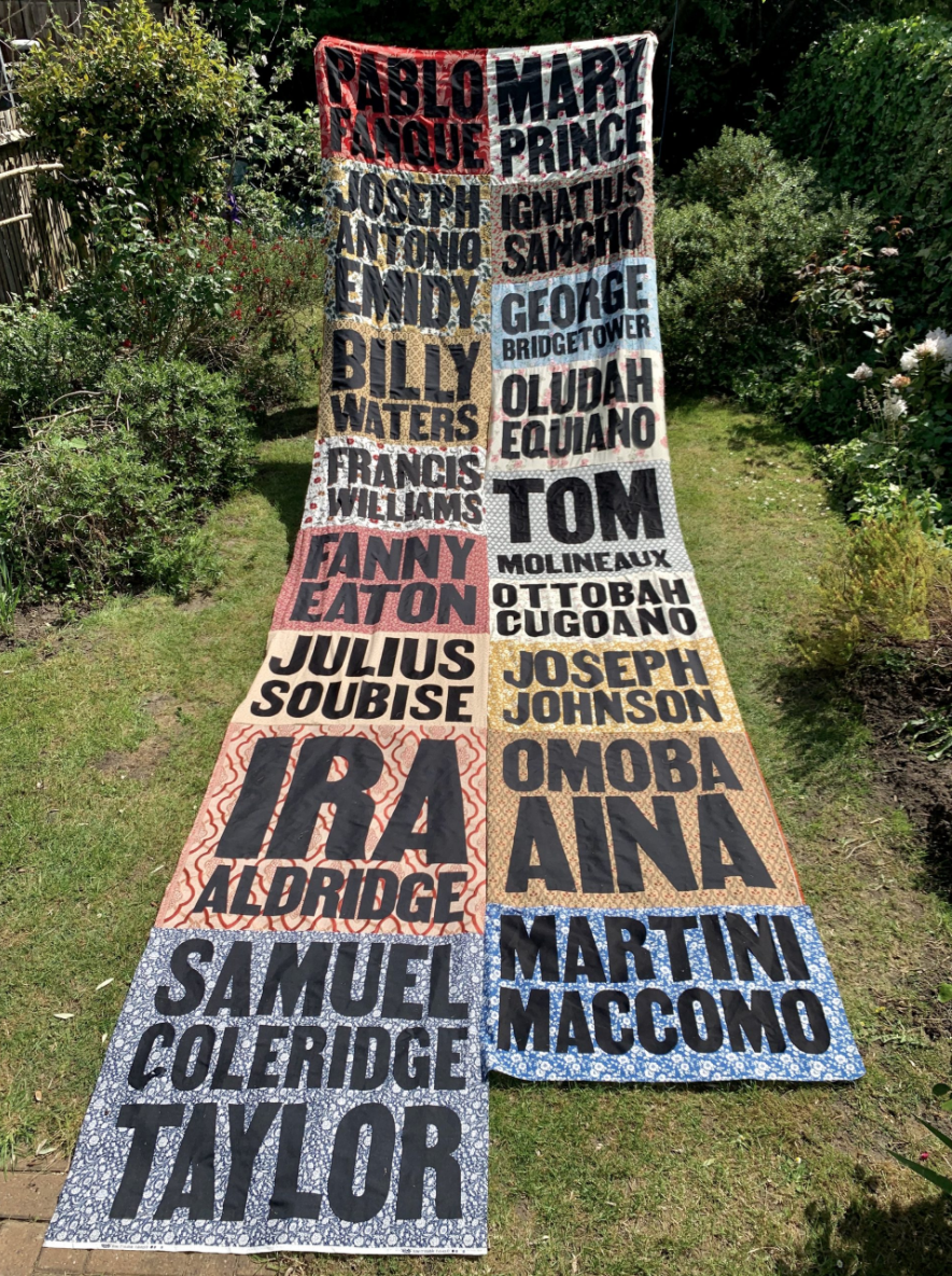 Long textile laid out with collection of names visible