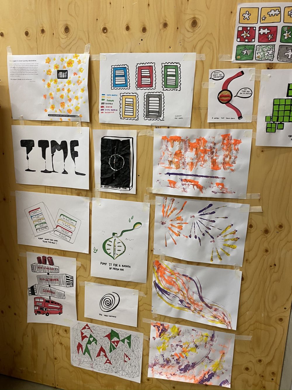 Different illustrations and drawings done on paper stuck up on the wall