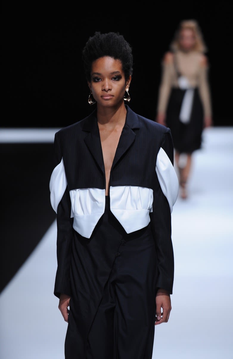 Female model wearing two piece black and white suit designed by Sijia Jiang