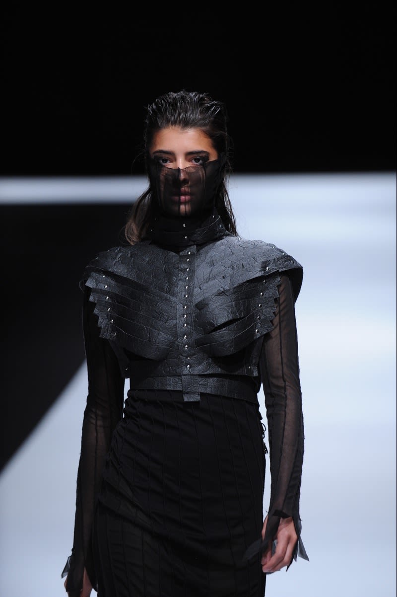 Female model wearing black jacket and face scarf designed by Eva Habanikova