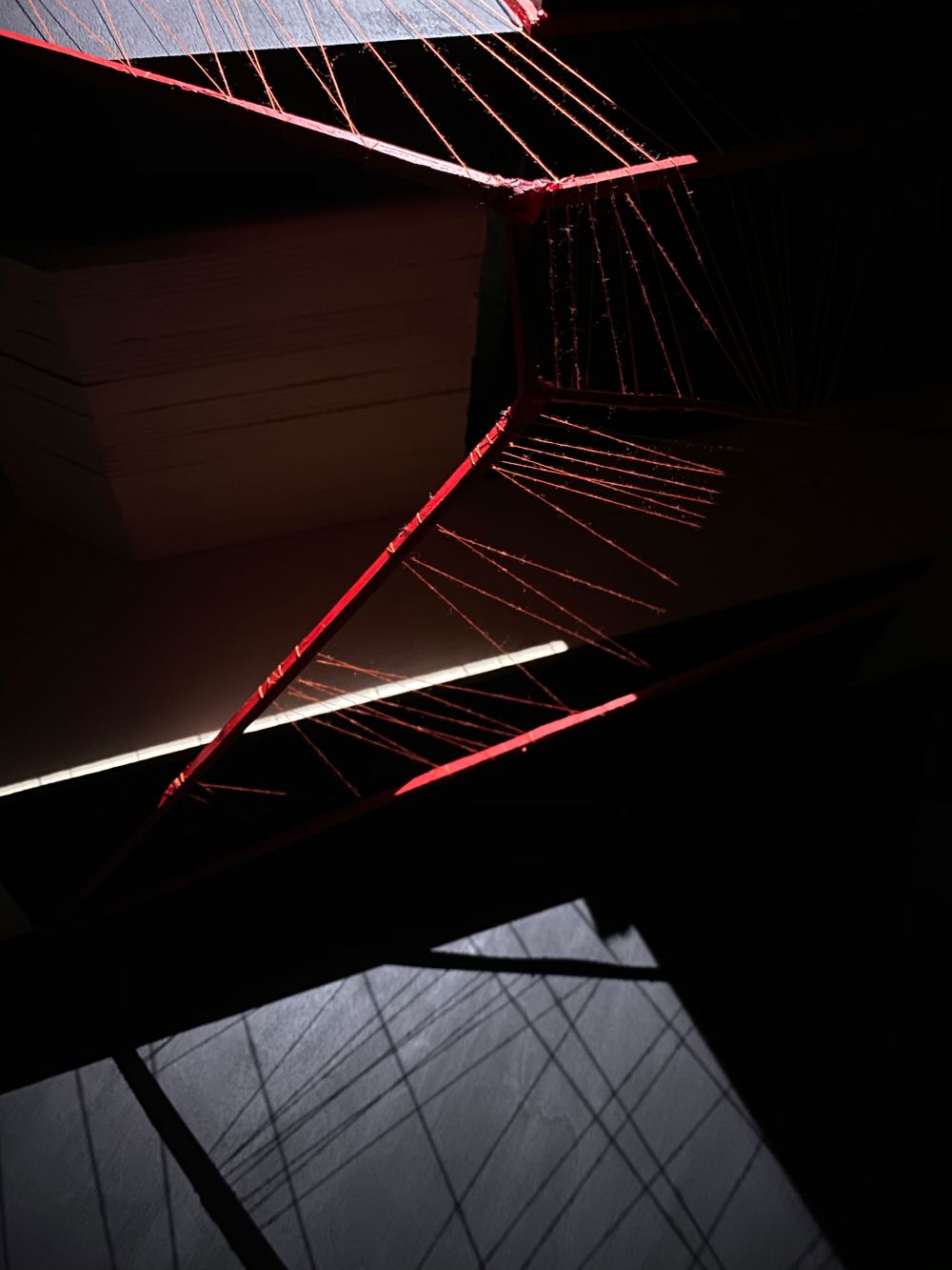 Model of structure made in card and red thread