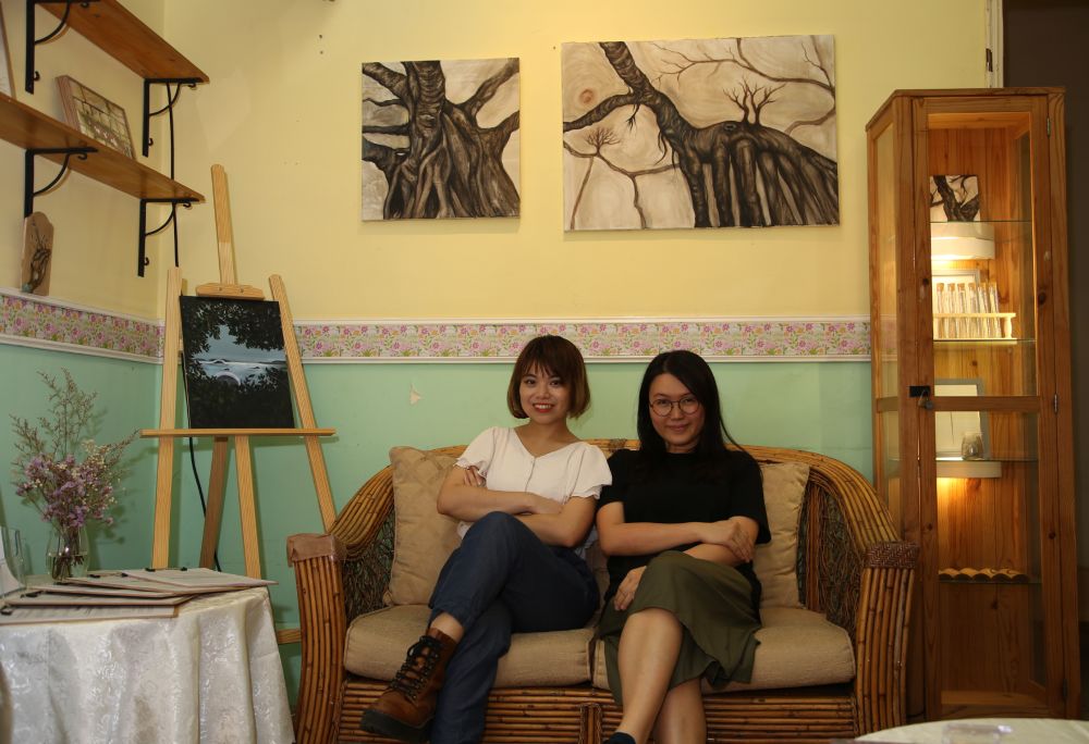 Artist with friend on sofa