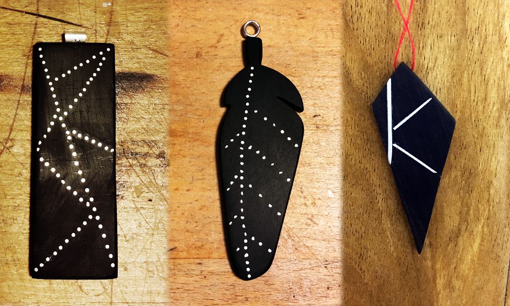 Three pendants (left to right): oblong with metal inlay / feather shaped with metal inlay / diamond shape with metal inlay