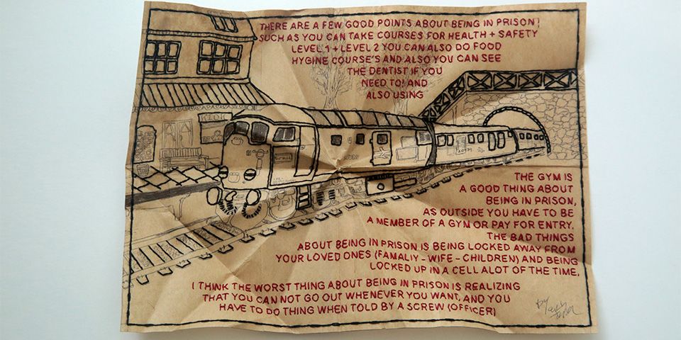 An intricate embroidery of a train which is surrounded by a quote, which is also embroidered 