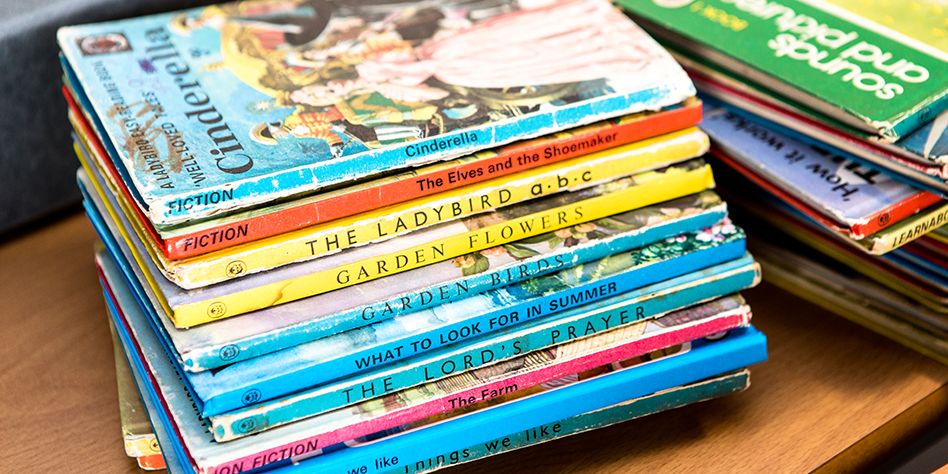 a pile of old lady bird books, they look well used, like they've been loved over the years