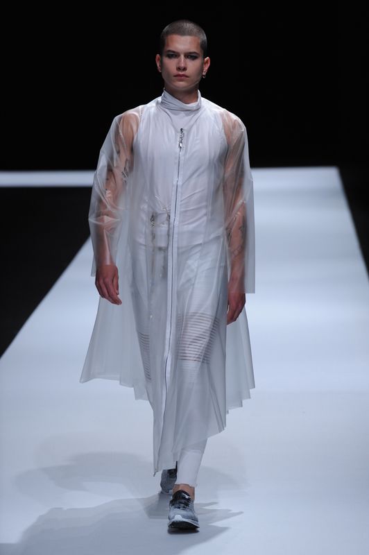 Male model in white clothing with clear perspex coat