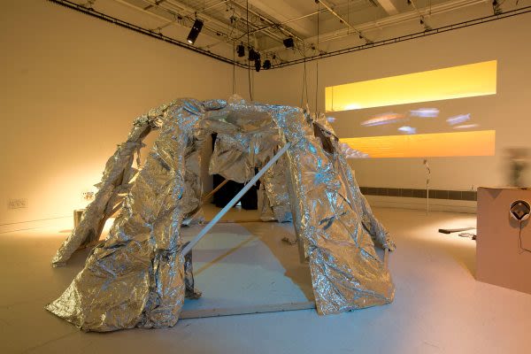Photograph of a sculpture made of a wooden frame and covered in tin foil