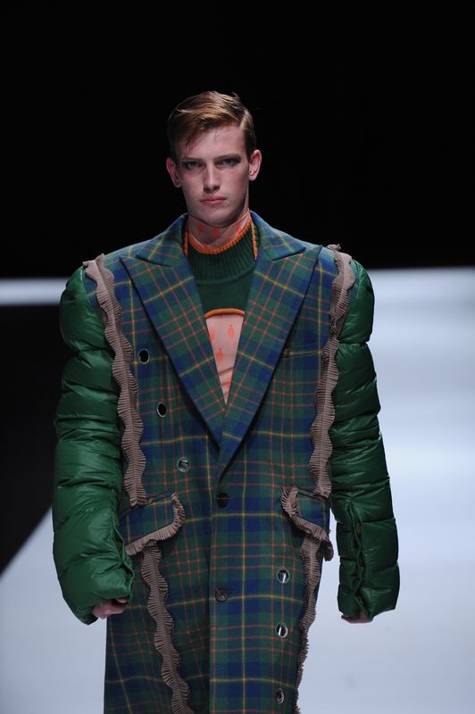 Male model in jacket with tartan body and green puffer sleeves