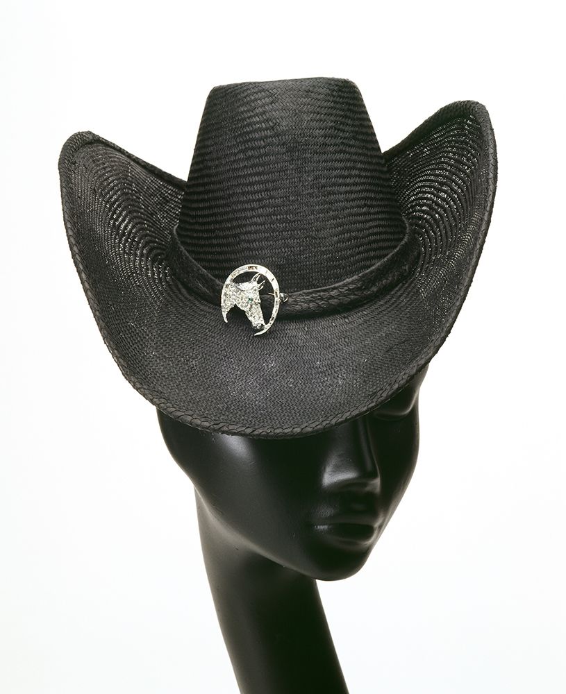 Black stetson hat with an upward arched brim sitting on top of a mannequin head.
