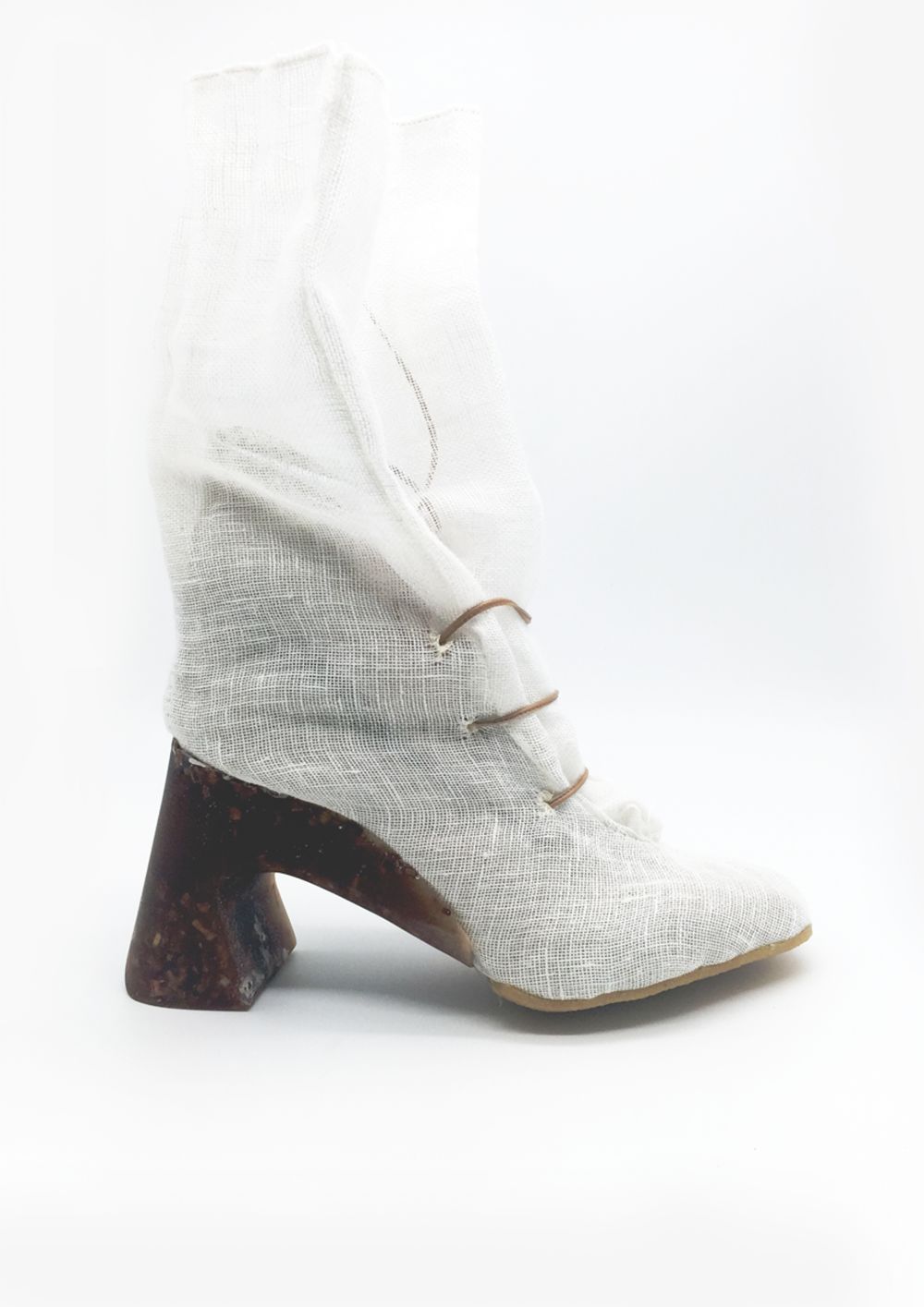 Heeled boot made of torn mesh material