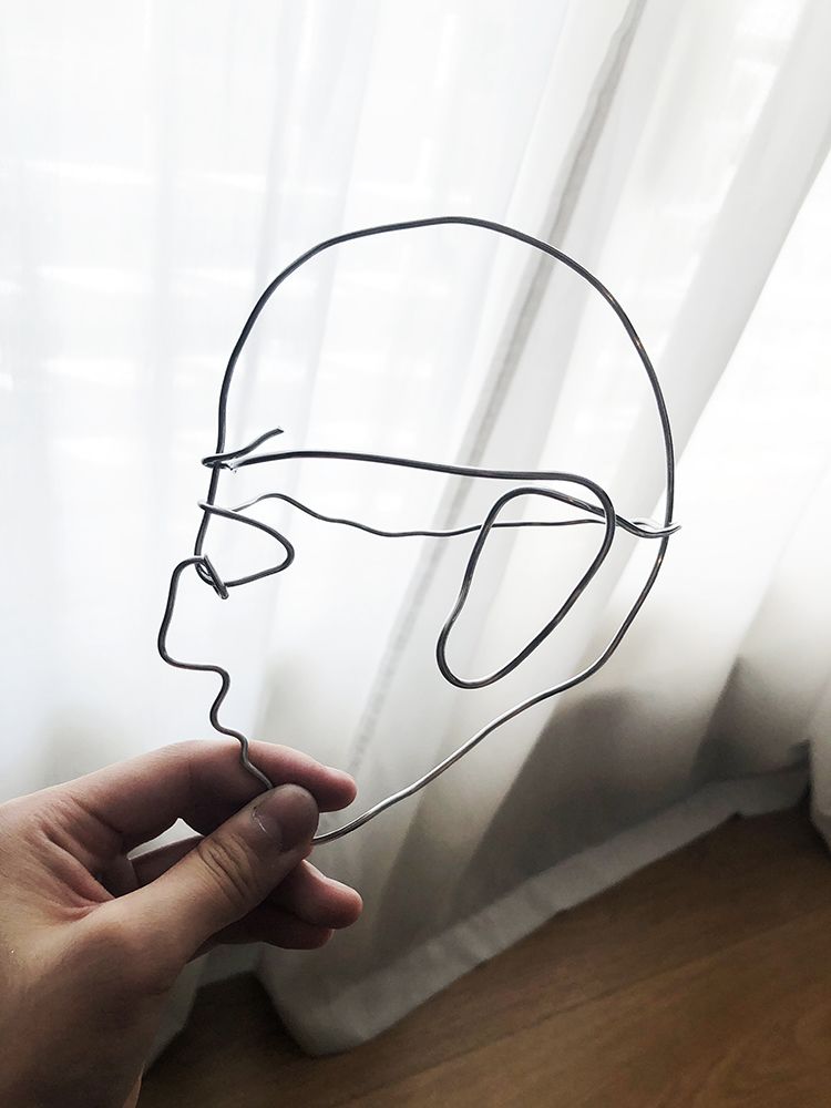 Wire sculpture shaped into a face.