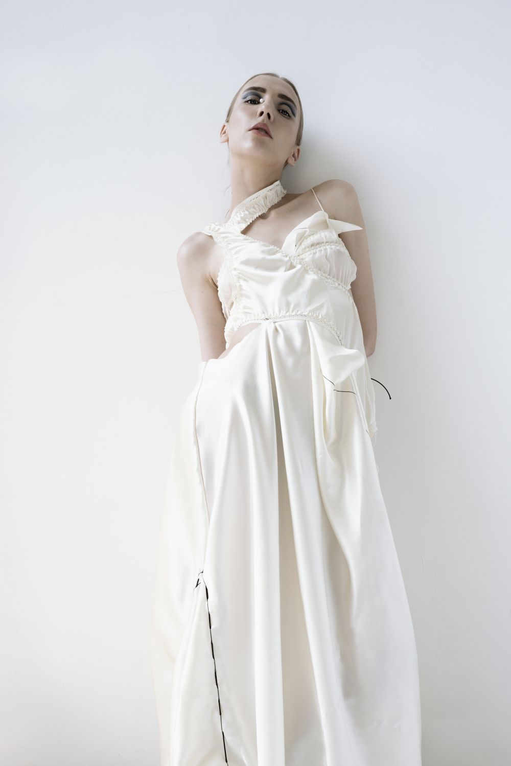 model in slinky patchwork white draped dress