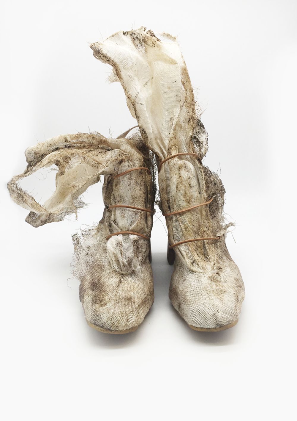 Heeled boot made of torn mesh material