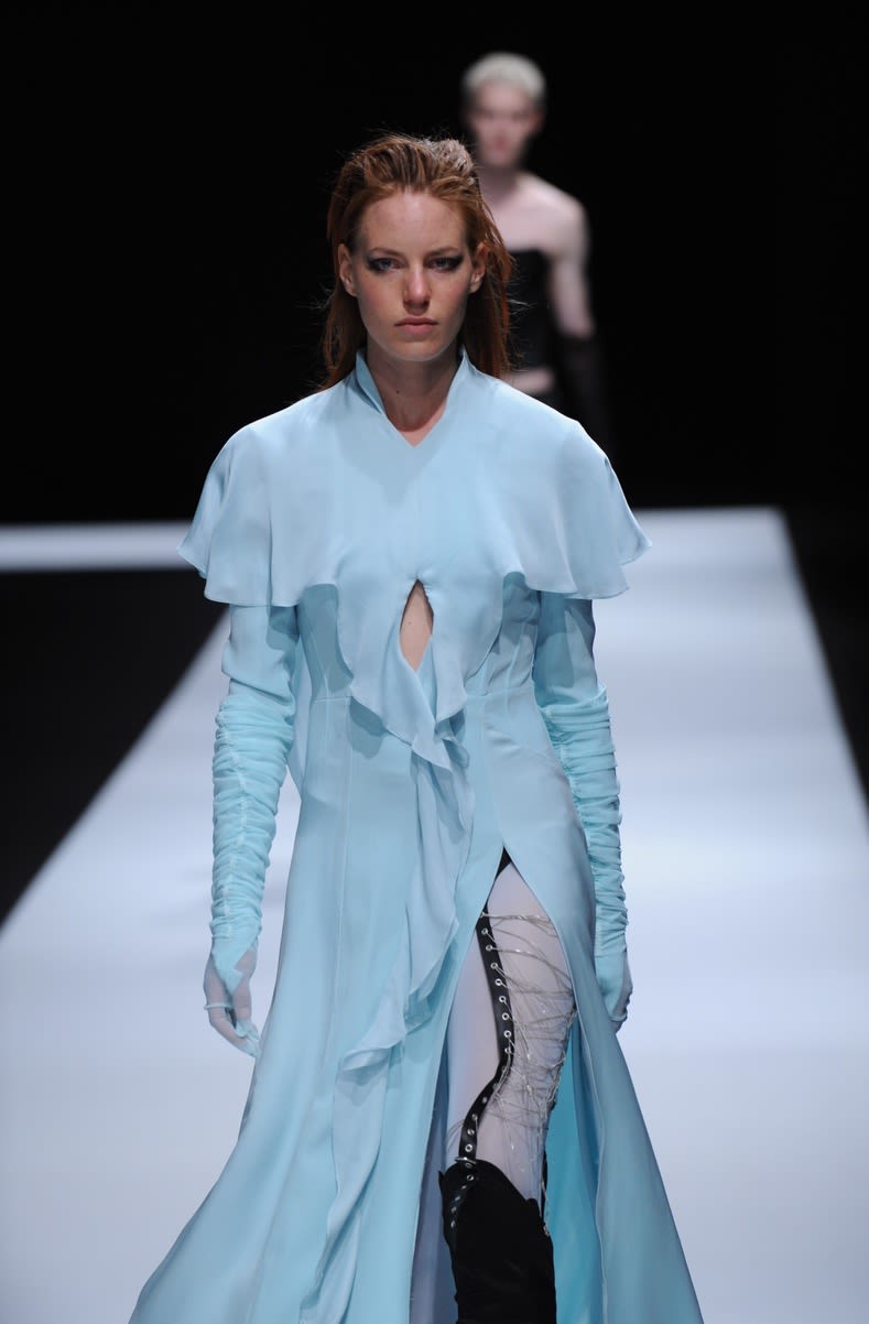 Female model wearing long blue dress designed by Katie Scotts 