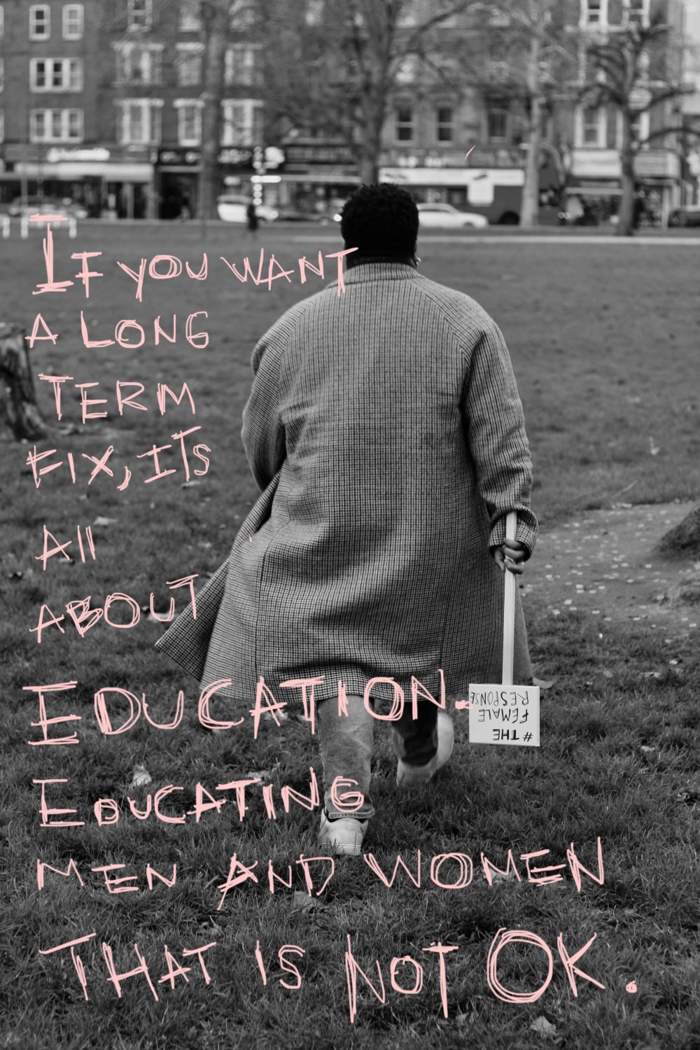 Back of person walking through a field wearing a check longline coat