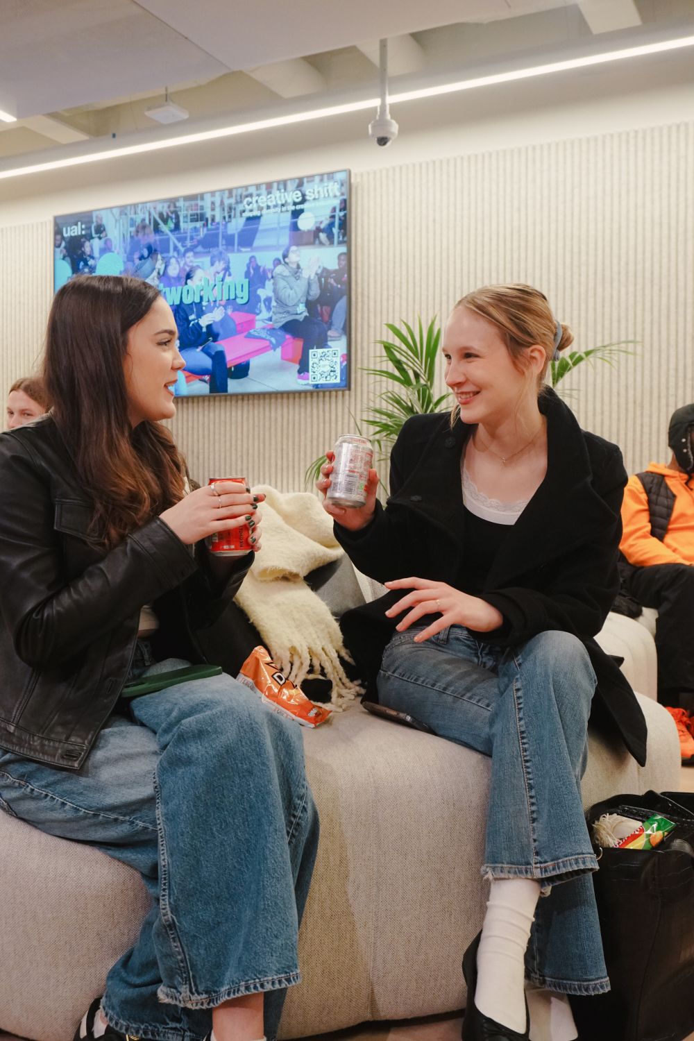 Two women having a conversation on a couch