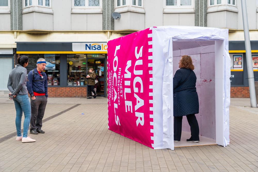 People interacting with a large installation on a high street
