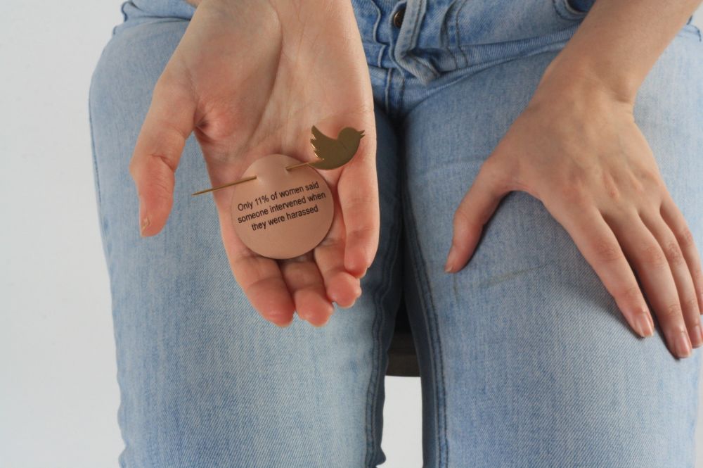 Model holding coin in open palm of hand