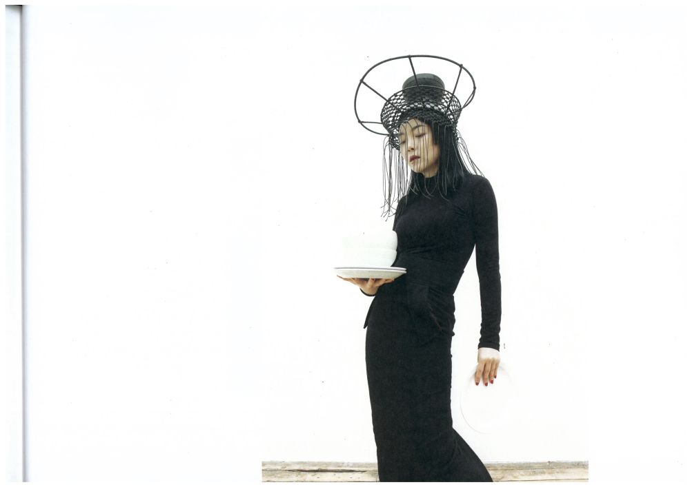 Model with metal framed hat on head