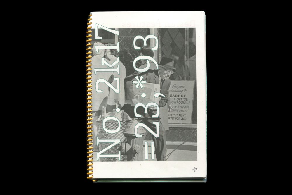 Photograph of a portfolio book, digits overlaid over image of a man on the front cover. 