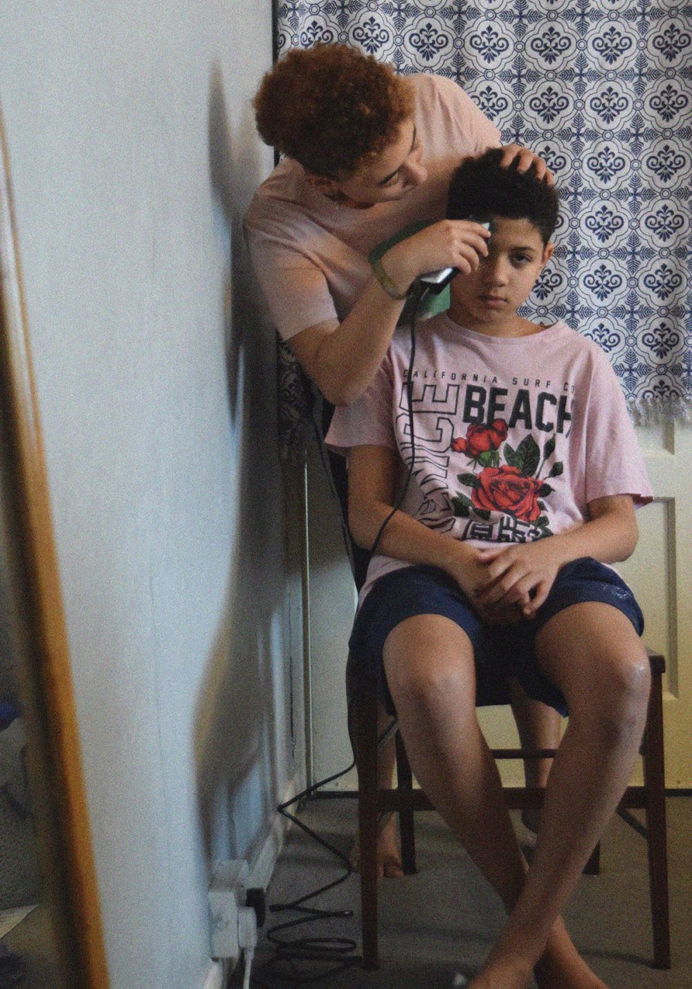 A photograph depicting a young boy getting a haircut.