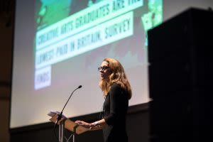 A Speaker presents on stage at UAL Awarding Body annual conference