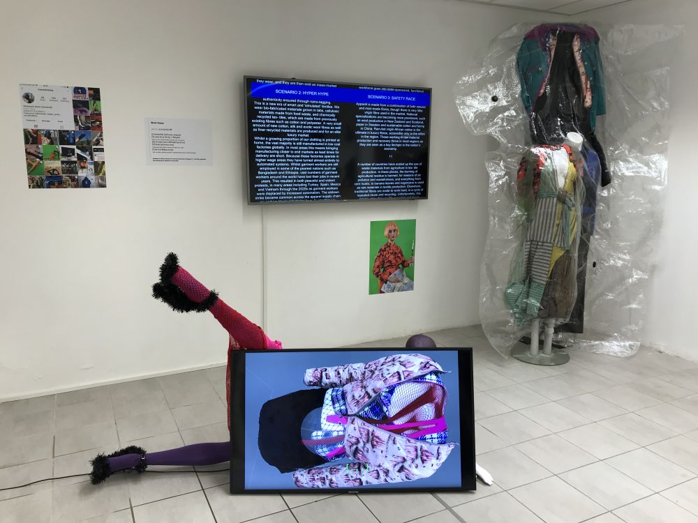 gallery installation with monitor and sculpture