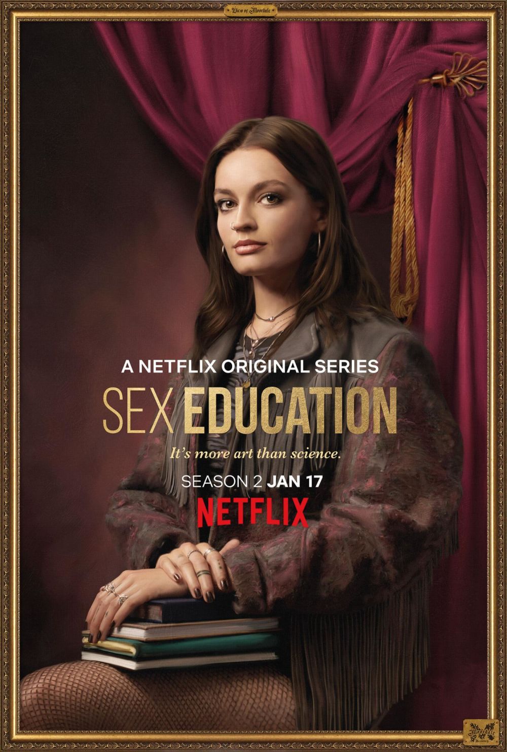 A promotional portrait of Maeve from the Netflix series, Sex Education, holding books.