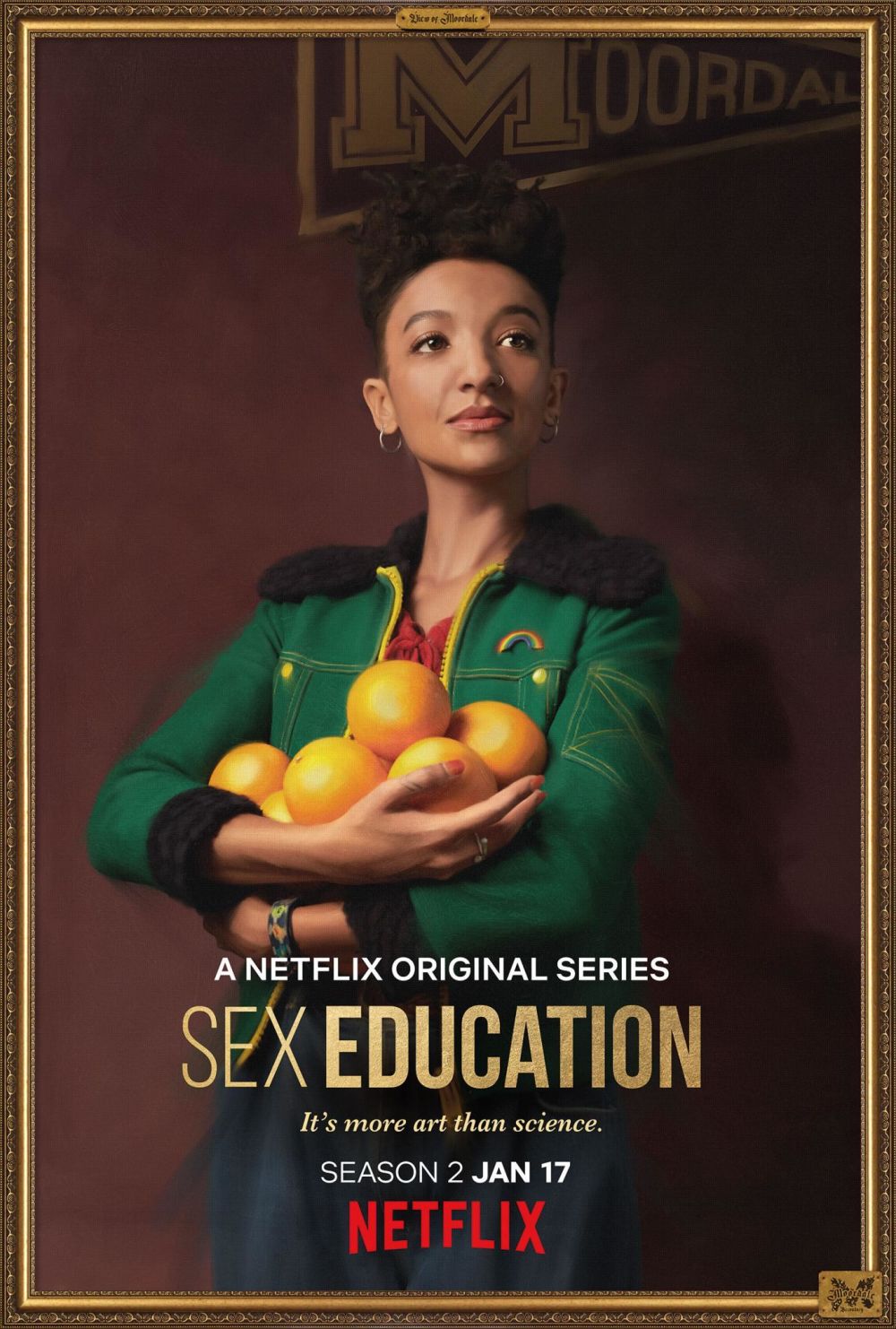 A promotional portrait of Maeve from the Netflix series, Sex Education, with an armful of oranges.