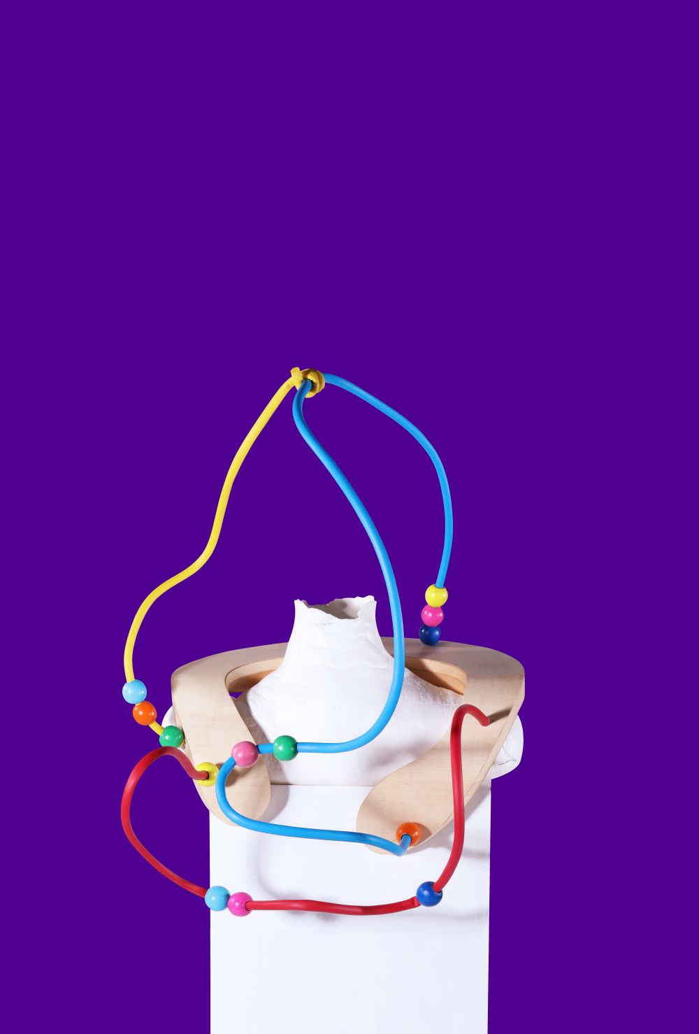 multicoloured wiring artefact attached to a neckbrace on top of a mannequin