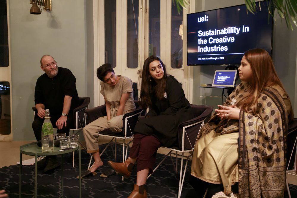 Photo of four people on a panel, sat in front of a screen which says 'UAL: Sustainability in the Creative Industries'
