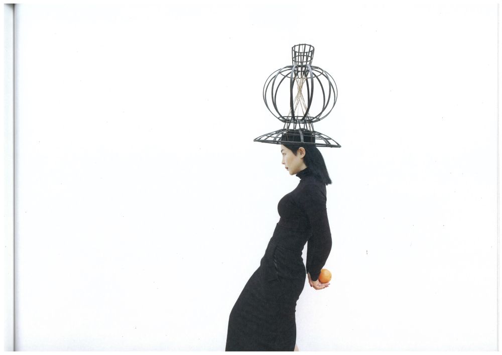 Model with metal framed hat on head