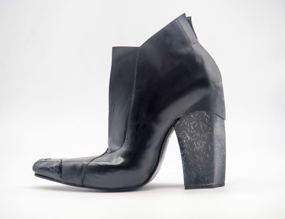 Black leather heeled boots with pointed toe