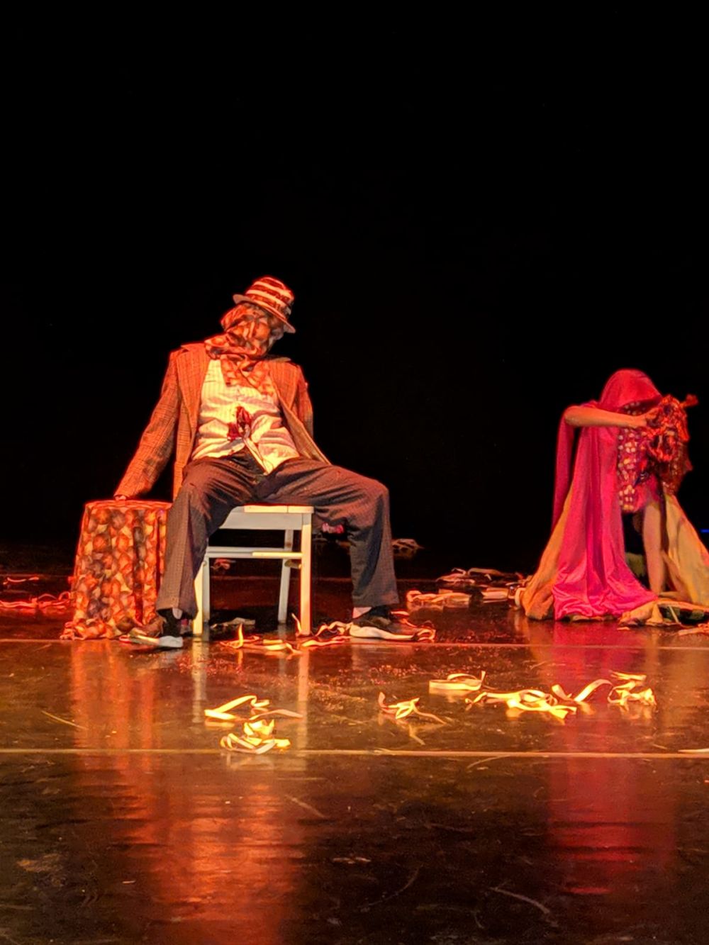 two characters on stage in old themed costumes 