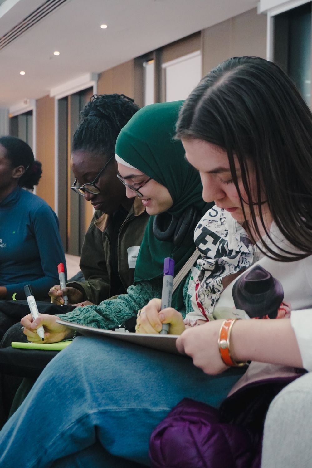 people taking notes at a conference 