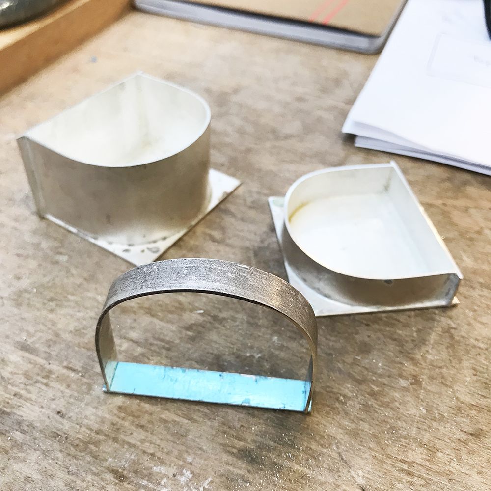 Shaped silver sections, ready to be assembled.
