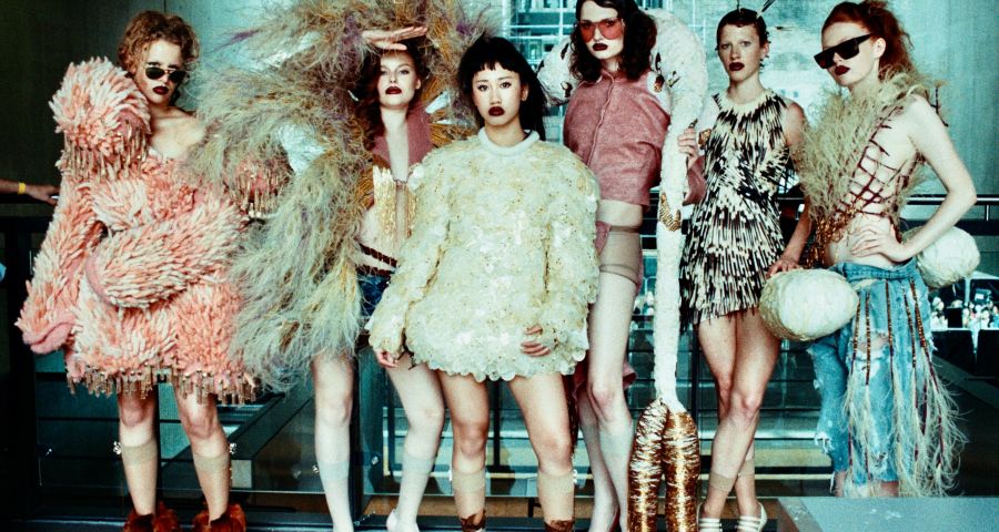 A group of six fashion models wearing knitwear designs