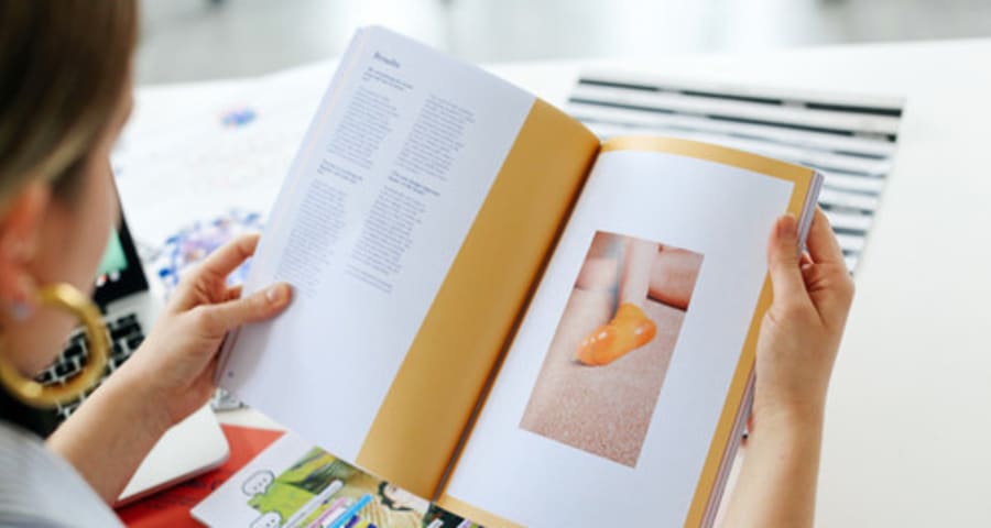 A student holding a magazine.