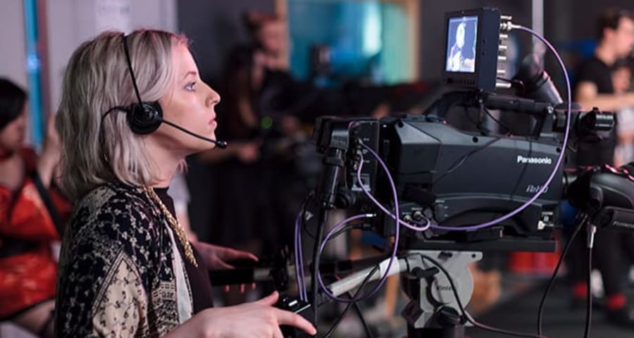 Student using camera in the Film and Television studio