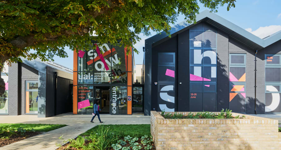 A person walks past the outside of Wimbledon College of Arts Building