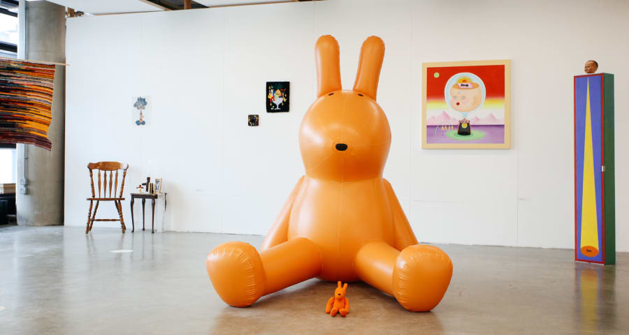 Large 3D rabbit, with a smaller 3D rabbit sat between their legs
