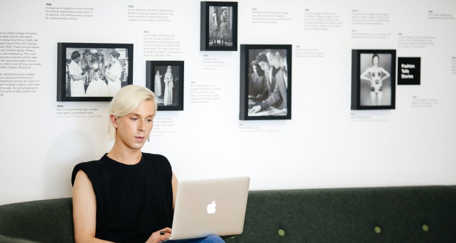 
                                        Student, Lauri Sallantaus, working on a laptop in the studio
                                        