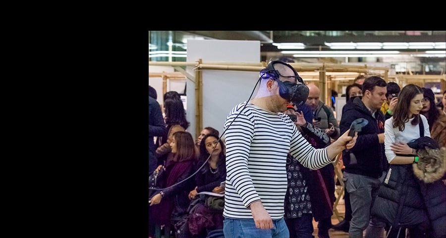Image of a man in a stripy t shirt wearing a VR headset from MA Applied Imagination Festival 2017