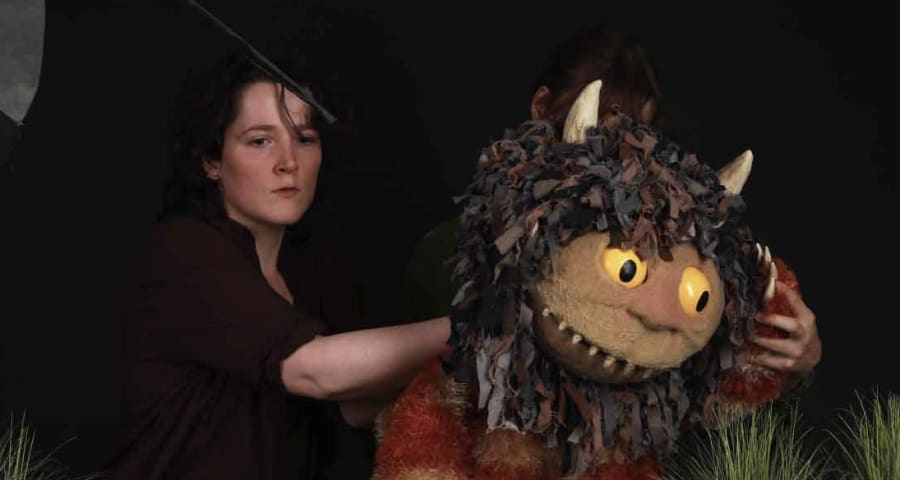 A student holds a life size puppet
