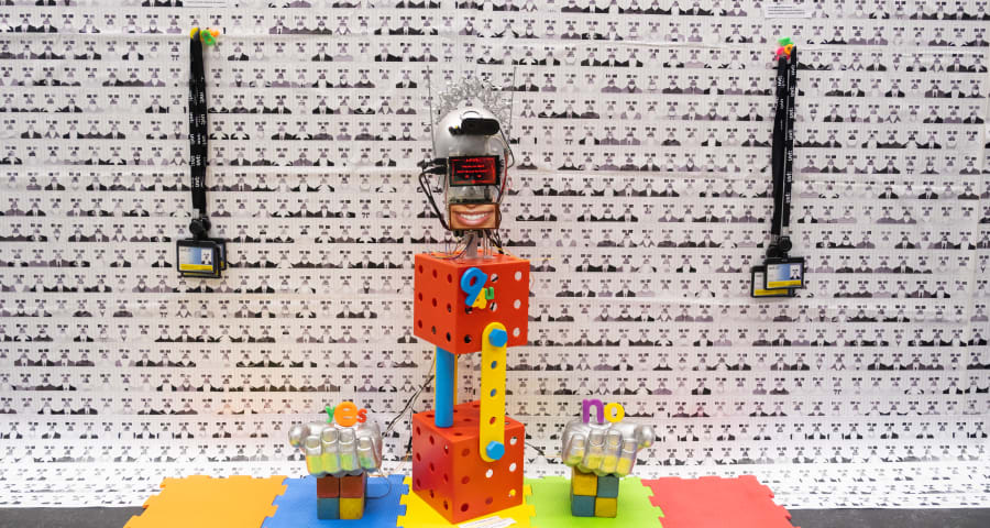 A robot installation with kids toys and tablet screens for face