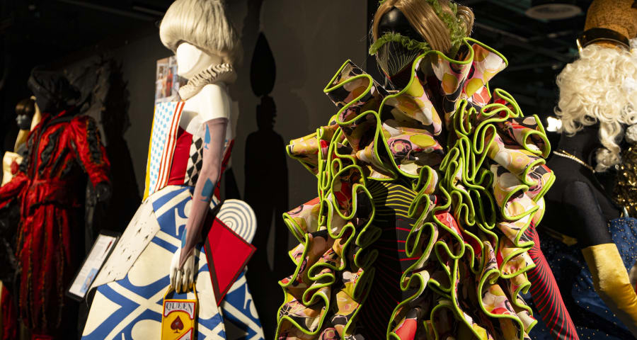 Multicoloured ruffled dress on a mannequin with other mannequins in the background